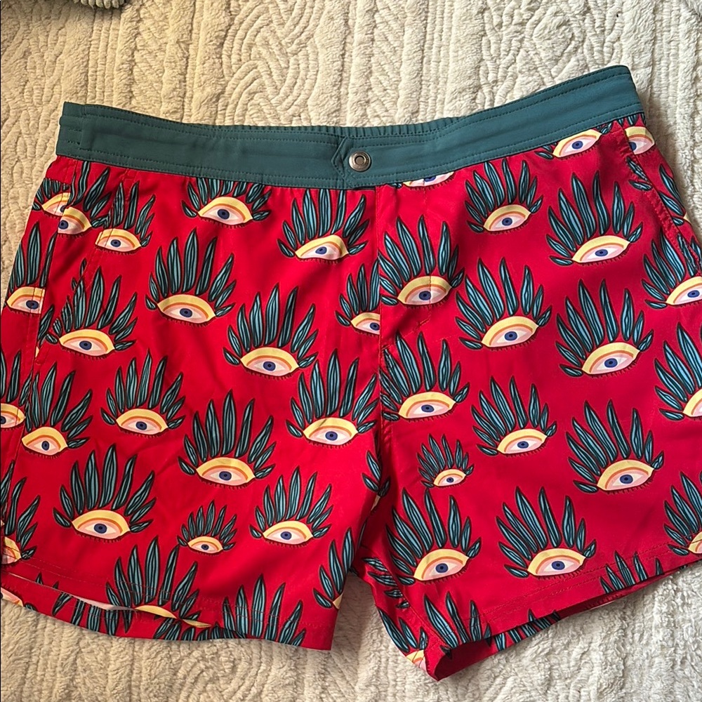 Vibrant Red and Green Swim Trunks with Eye Pattern